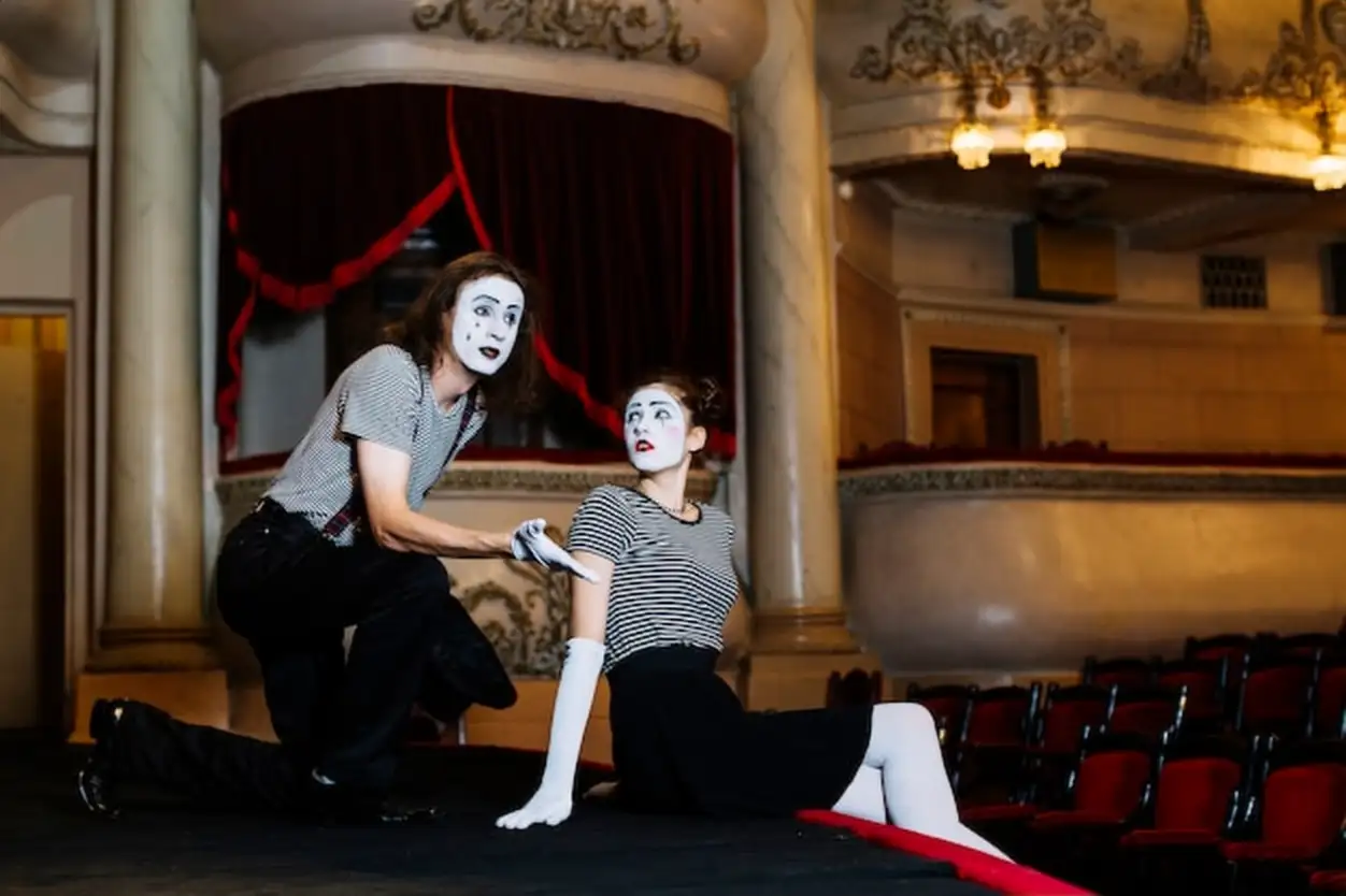 Couple mime artist performing on stage in the auditorium