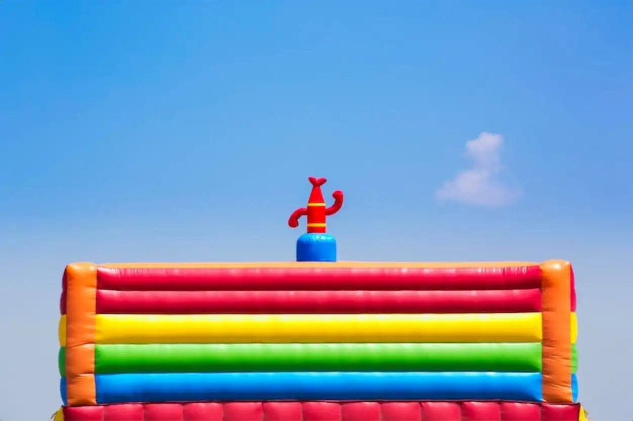 Low angle view of colorful inflatable balloon against sky