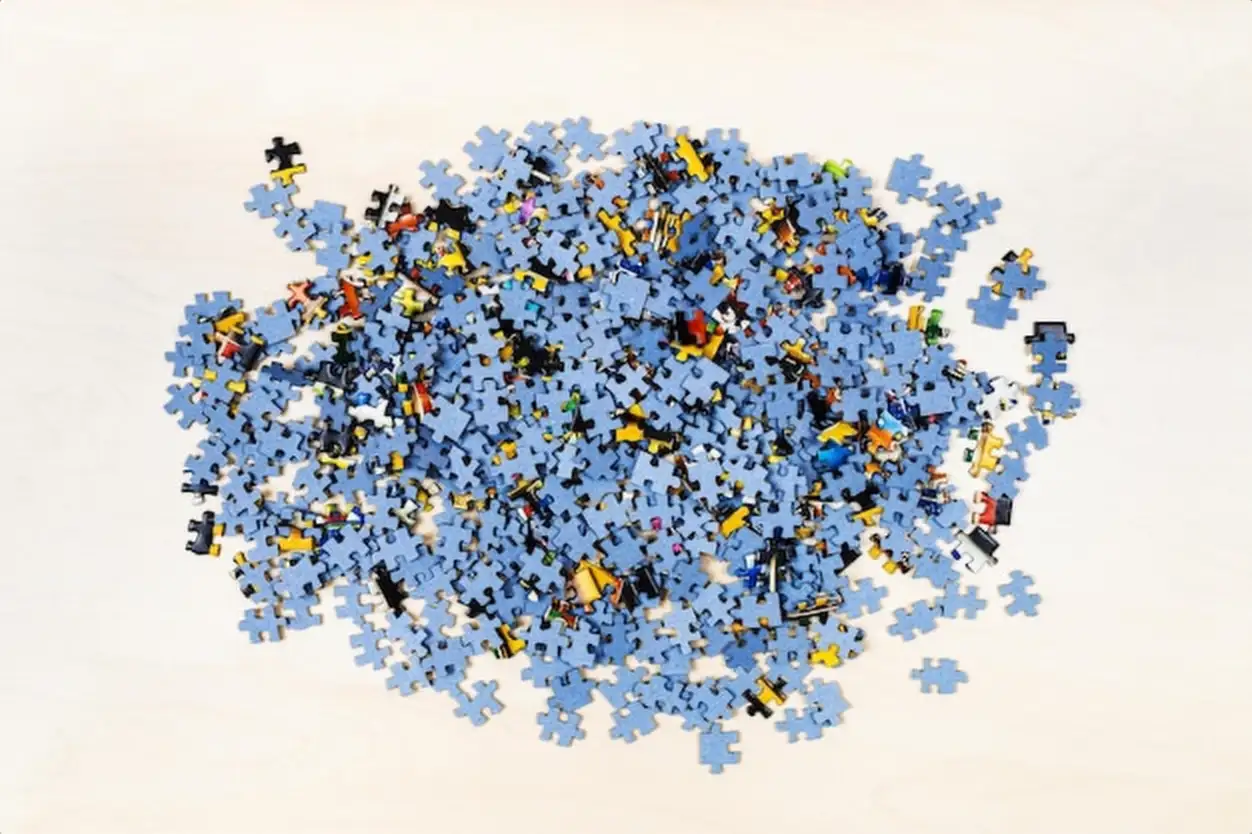 Top view of pile of puzzle pieces on table