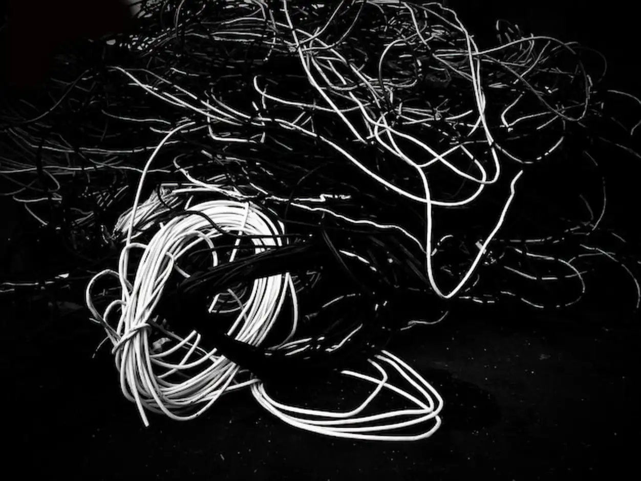 High angle view of tangled cables on field