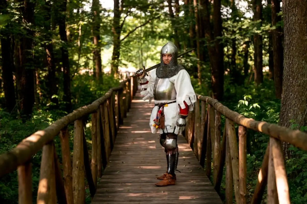 Full shot man posing as a medieval soldier
