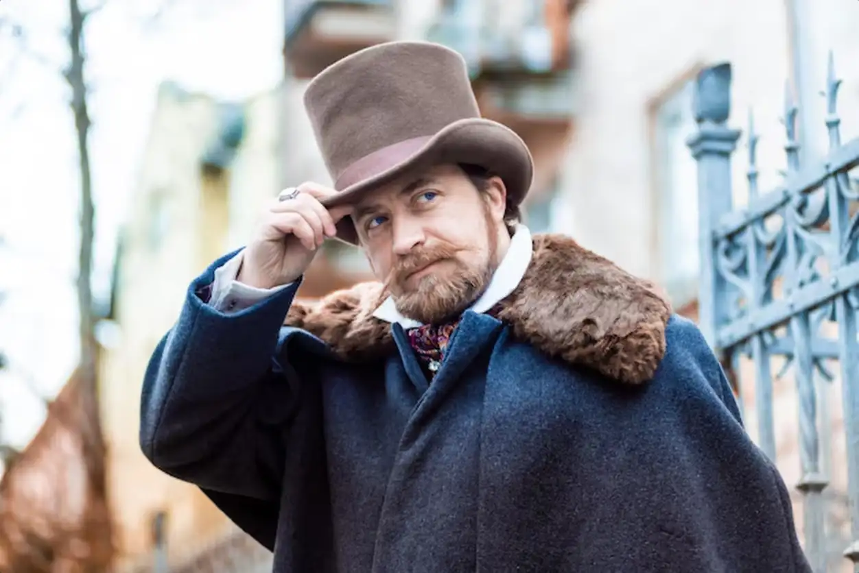 Elegant man. The gentleman in a coat and a top hat