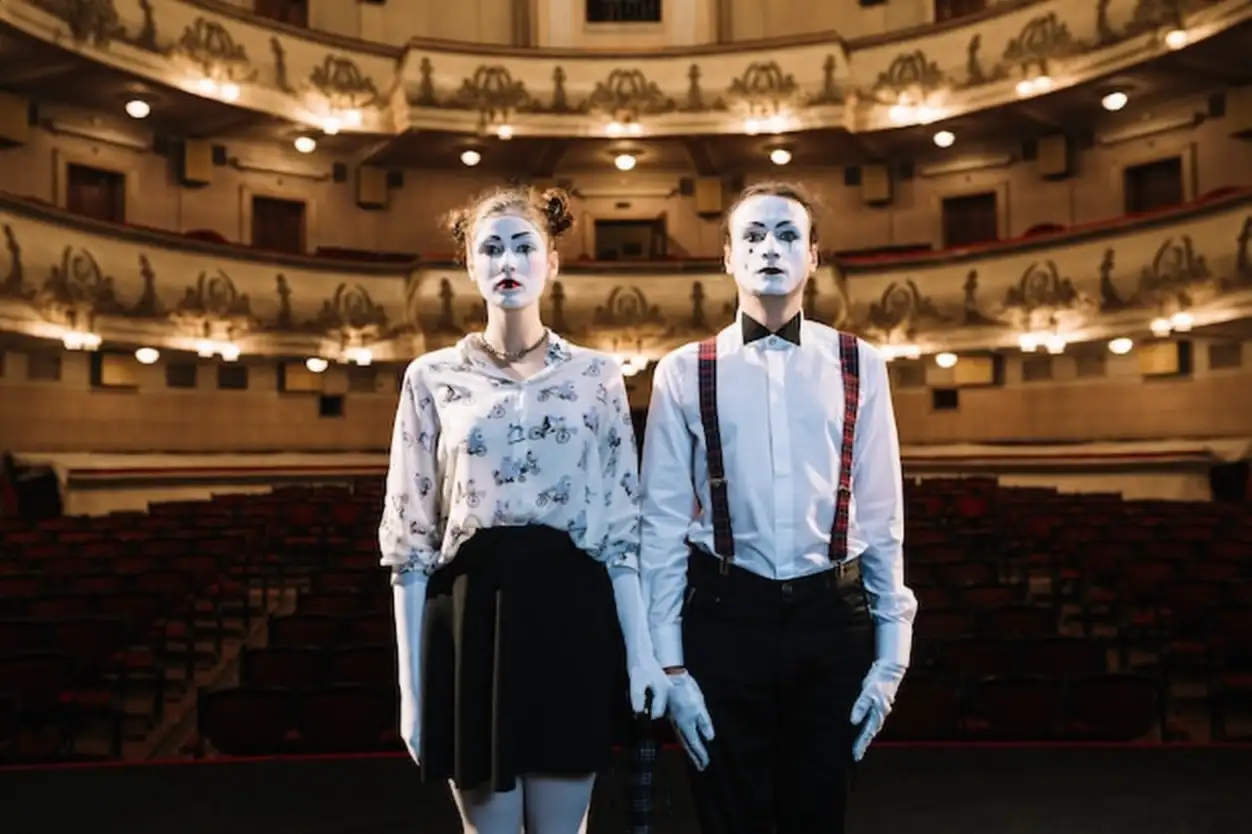 Close-up of serious mime artist standing in the auditorium