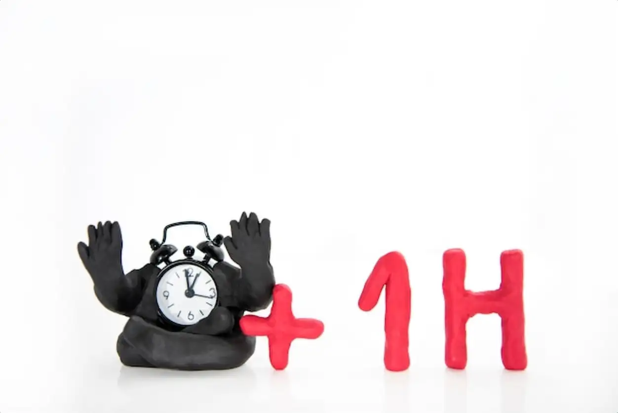 Close-up of toy and clock against white background