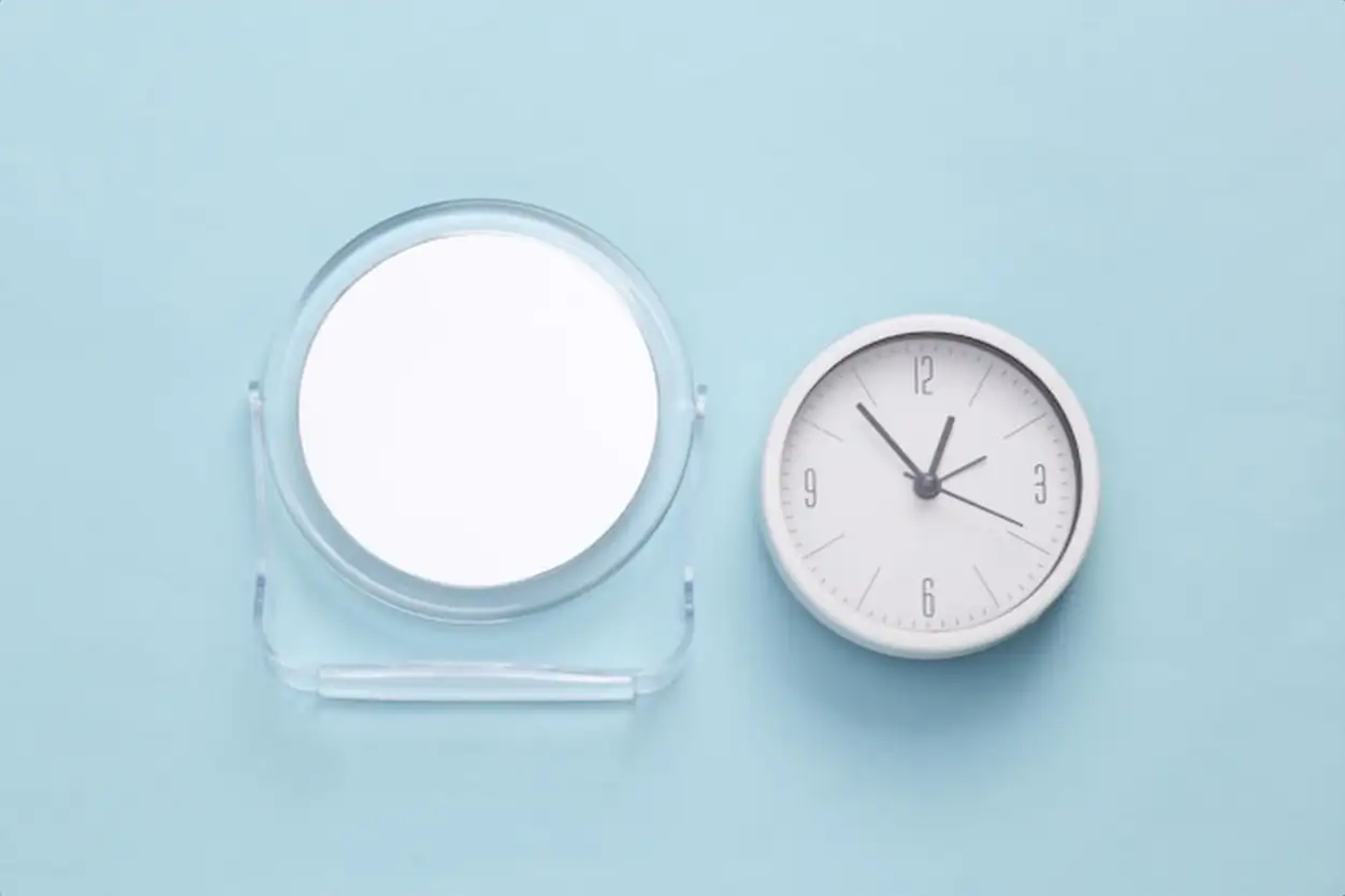Mirror with a clock on a blue background