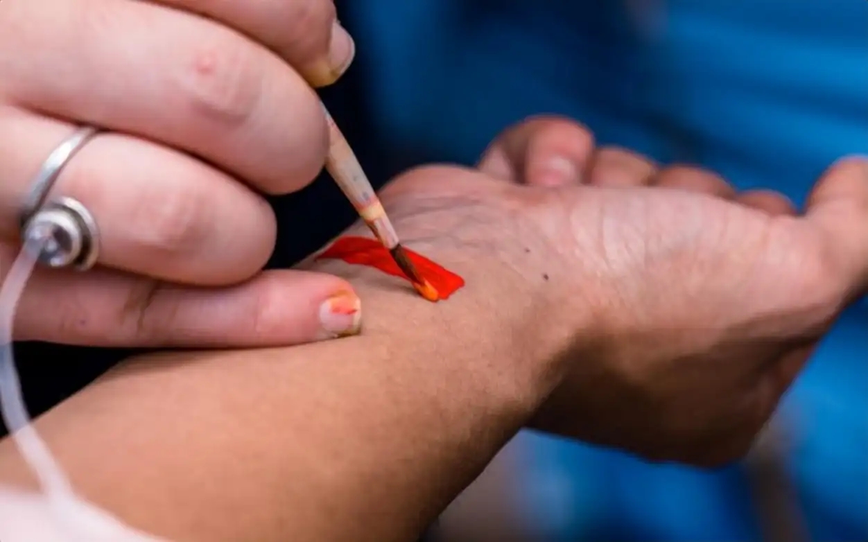 LGBTQ members painting rainbow color on body to celebrate LGBTQ pride parade festival at Kathmandu