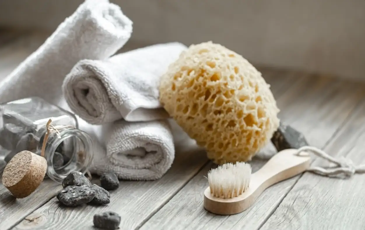 Spa composition with stones, towels, washcloth and bath brush. Health and beauty concept.