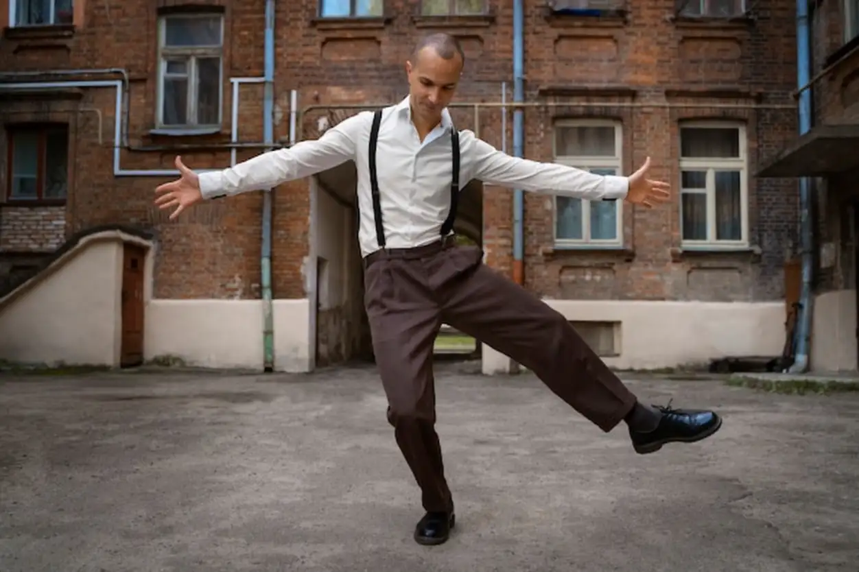 Man swing dancing outdoors full shot