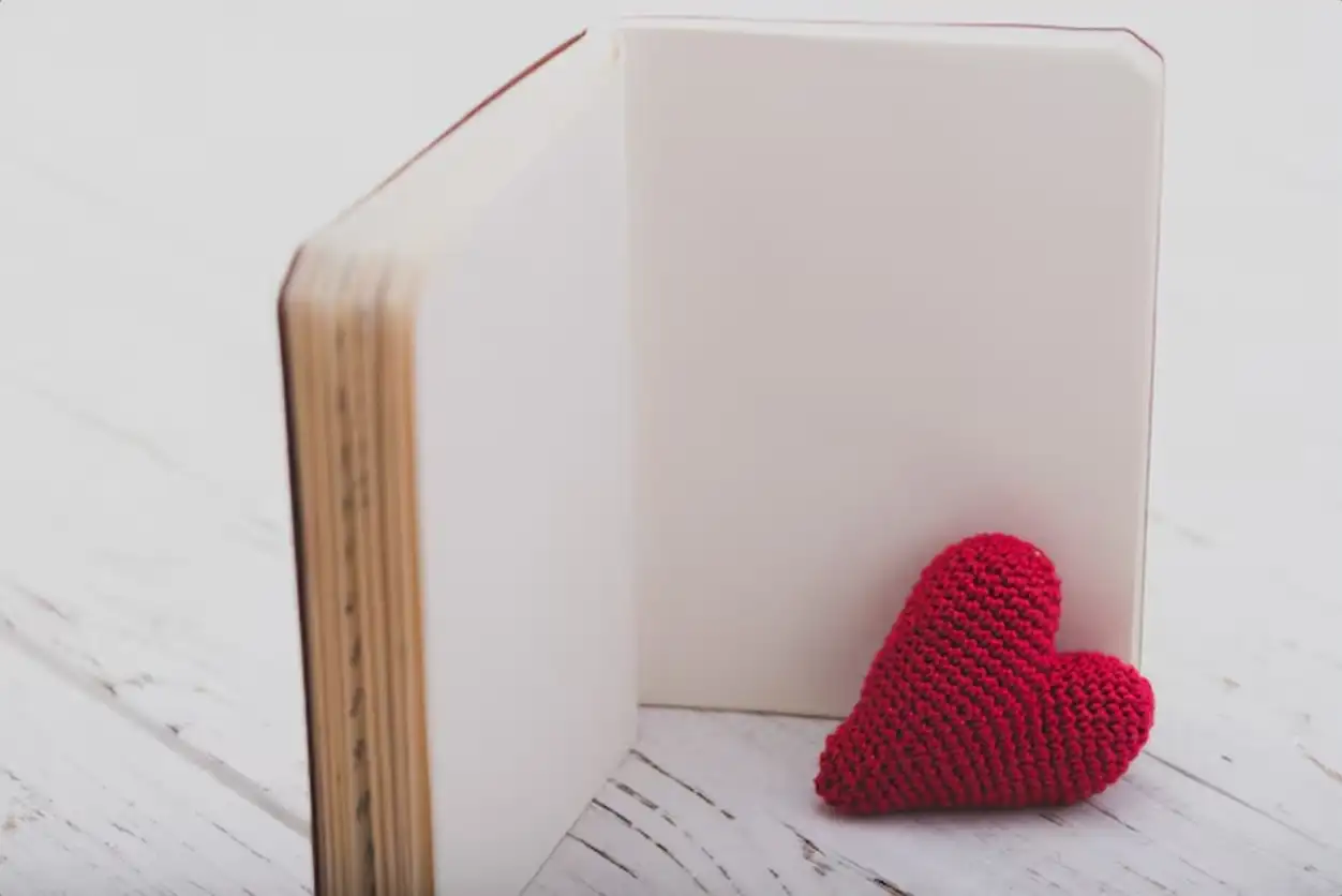 Blank book with a heart next to it