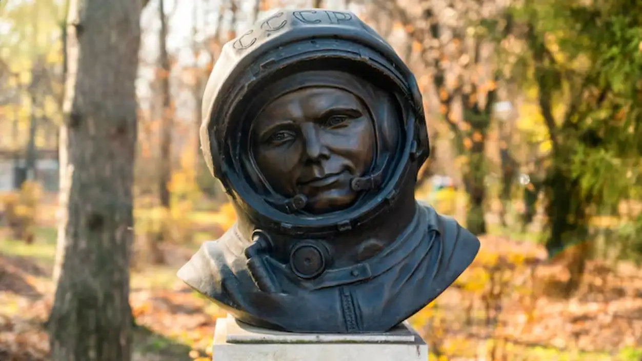 Yuri Gagarin bust in a park in Bucharest Romania Yellowed trees on the background