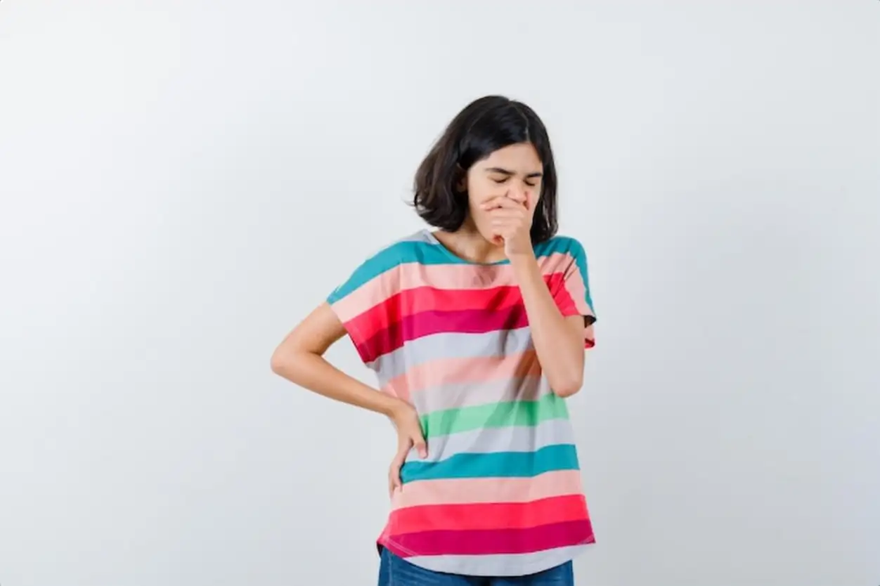 Little girl yawning in t-shirt and looking sleepy , front view.